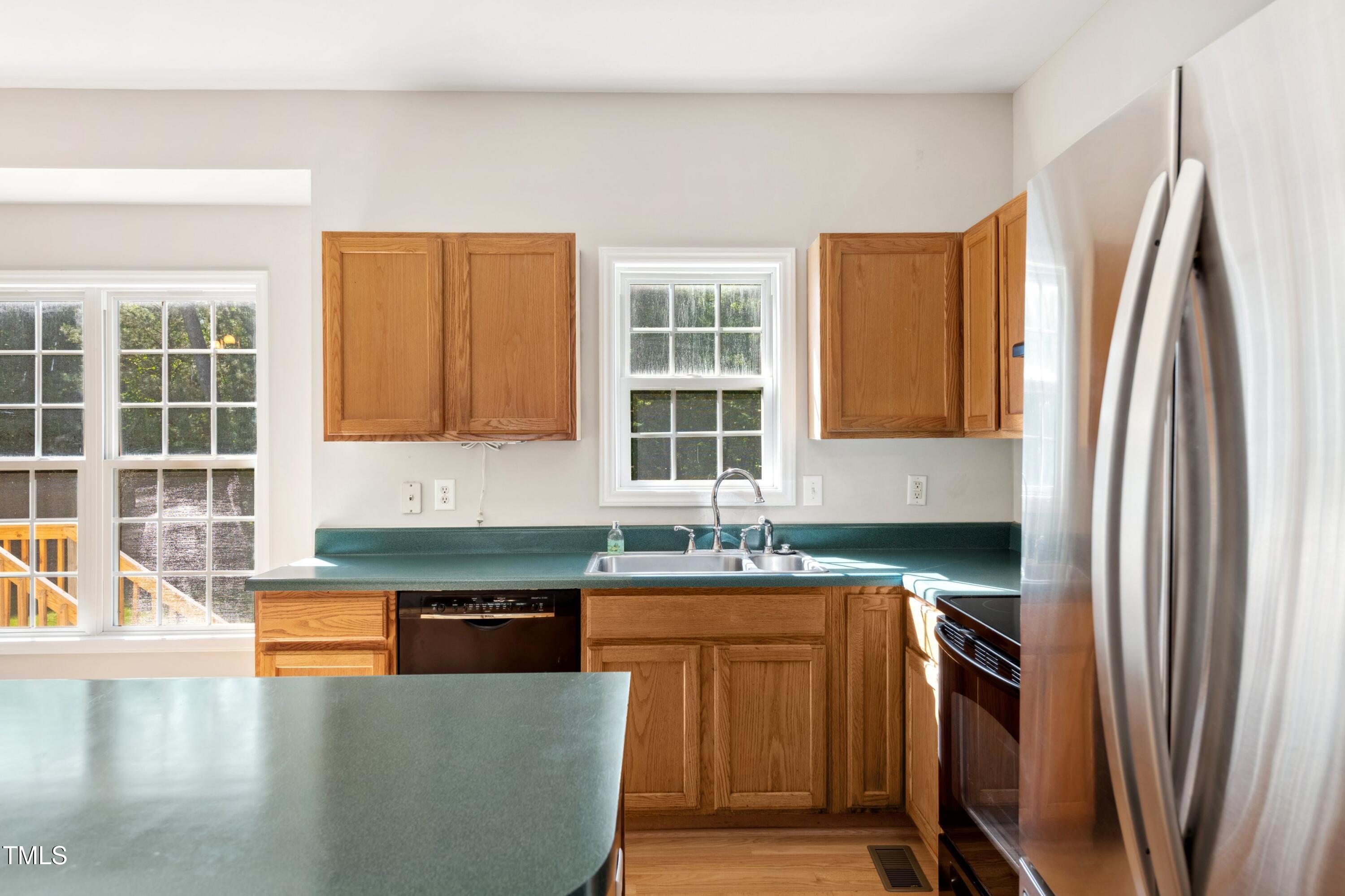 1909 Redding Lane Durham, NC 27712 - Photo 21 of 49 a kitchen with stainless steel appliances granite countertop a refrigerator a sink a stove and island
