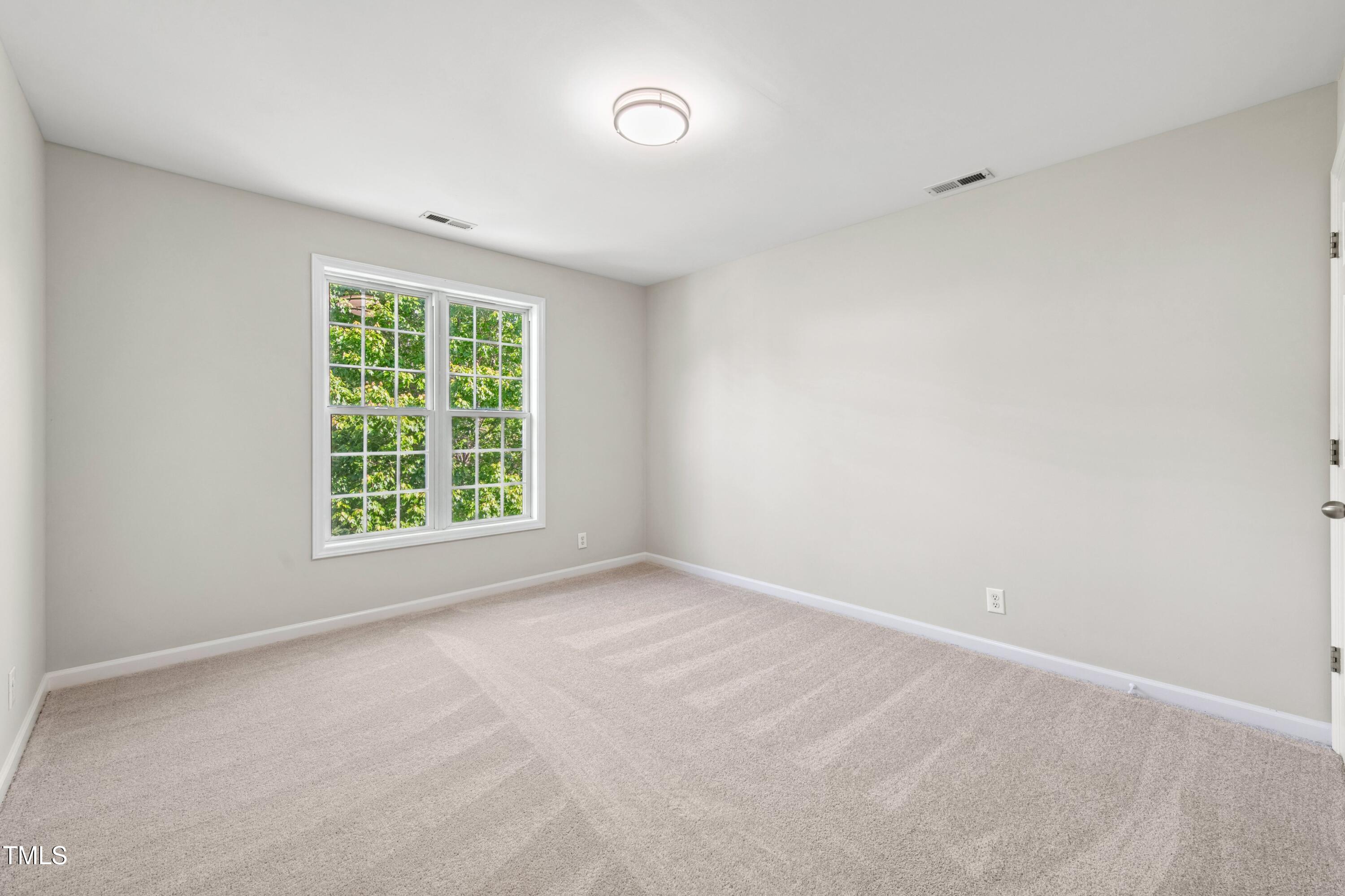 1909 Redding Lane Durham, NC 27712 - Photo 24 of 49 an empty room with a window