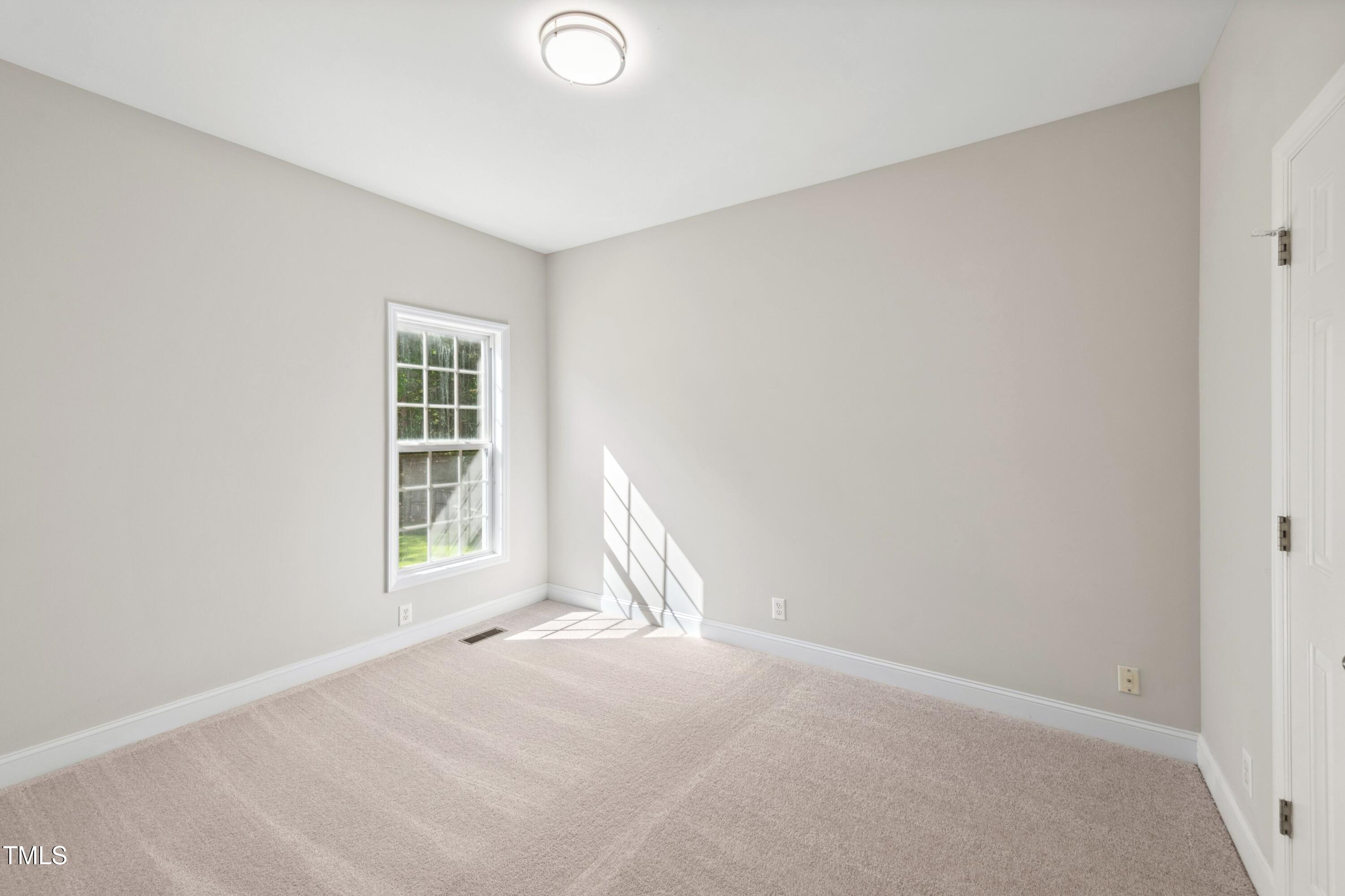 1909 Redding Lane Durham, NC 27712 - Photo 28 of 49 an empty room with windows