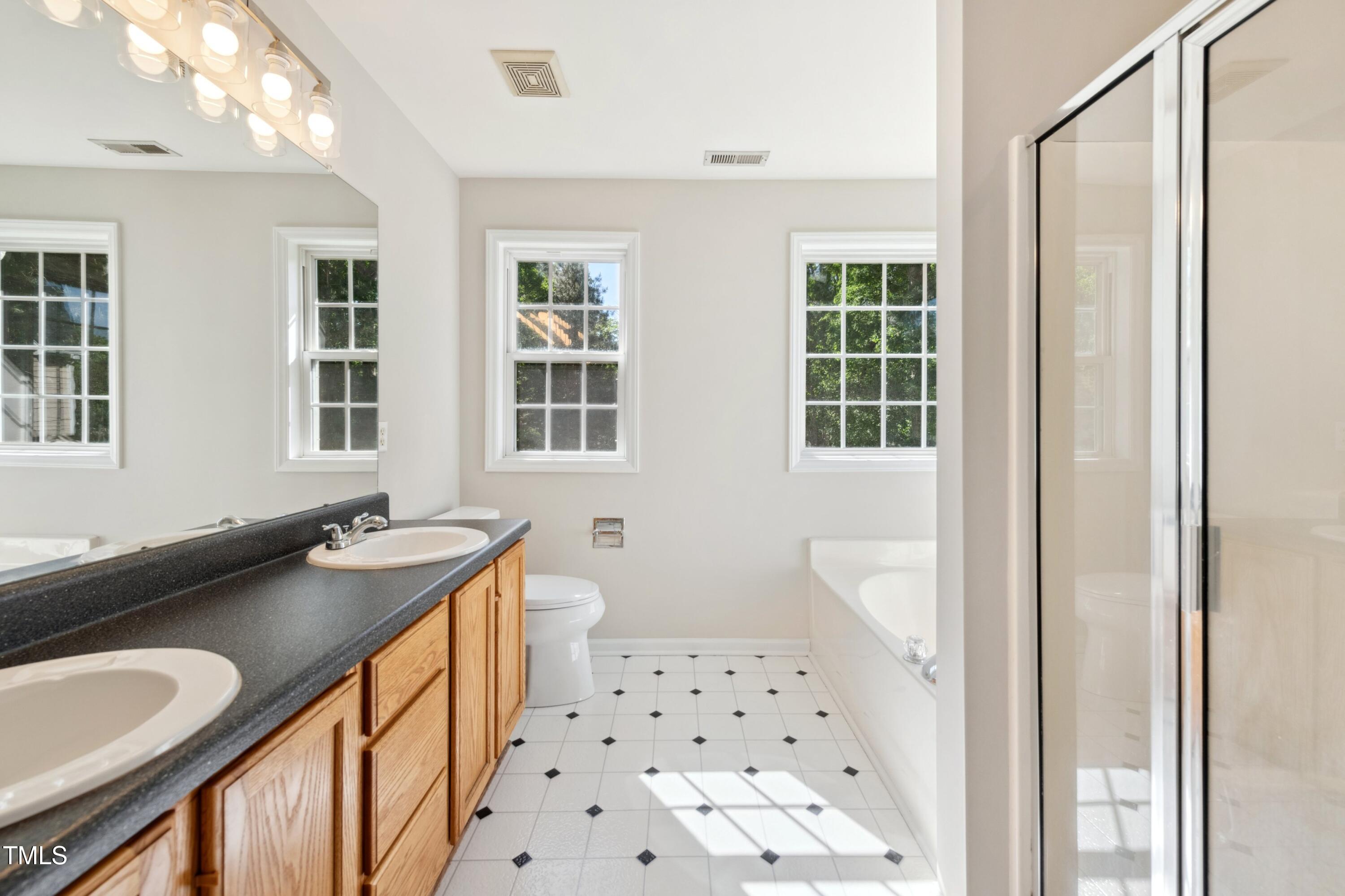 1909 Redding Lane Durham, NC 27712 - Photo 36 of 49 a bathroom with a sink toilet a mirror and shower