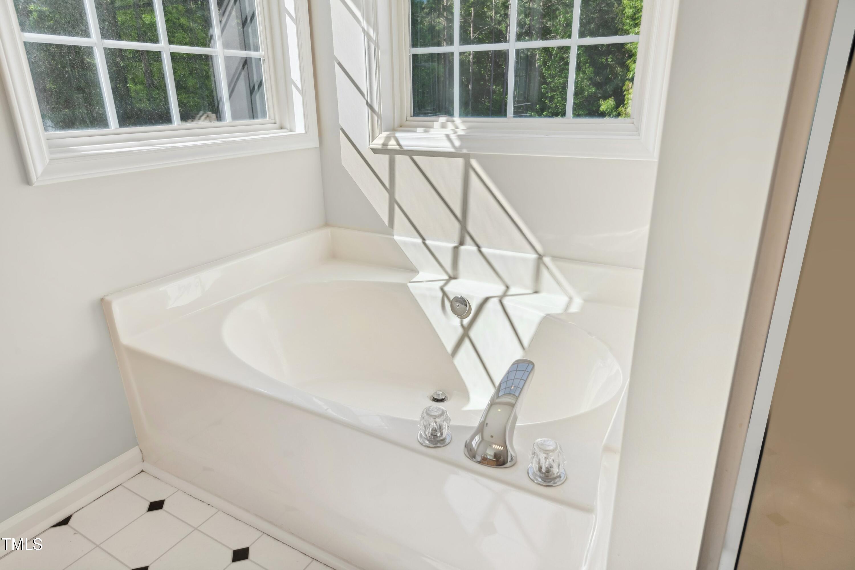 1909 Redding Lane Durham, NC 27712 - Photo 37 of 49 a white bath tub sitting next to a window
