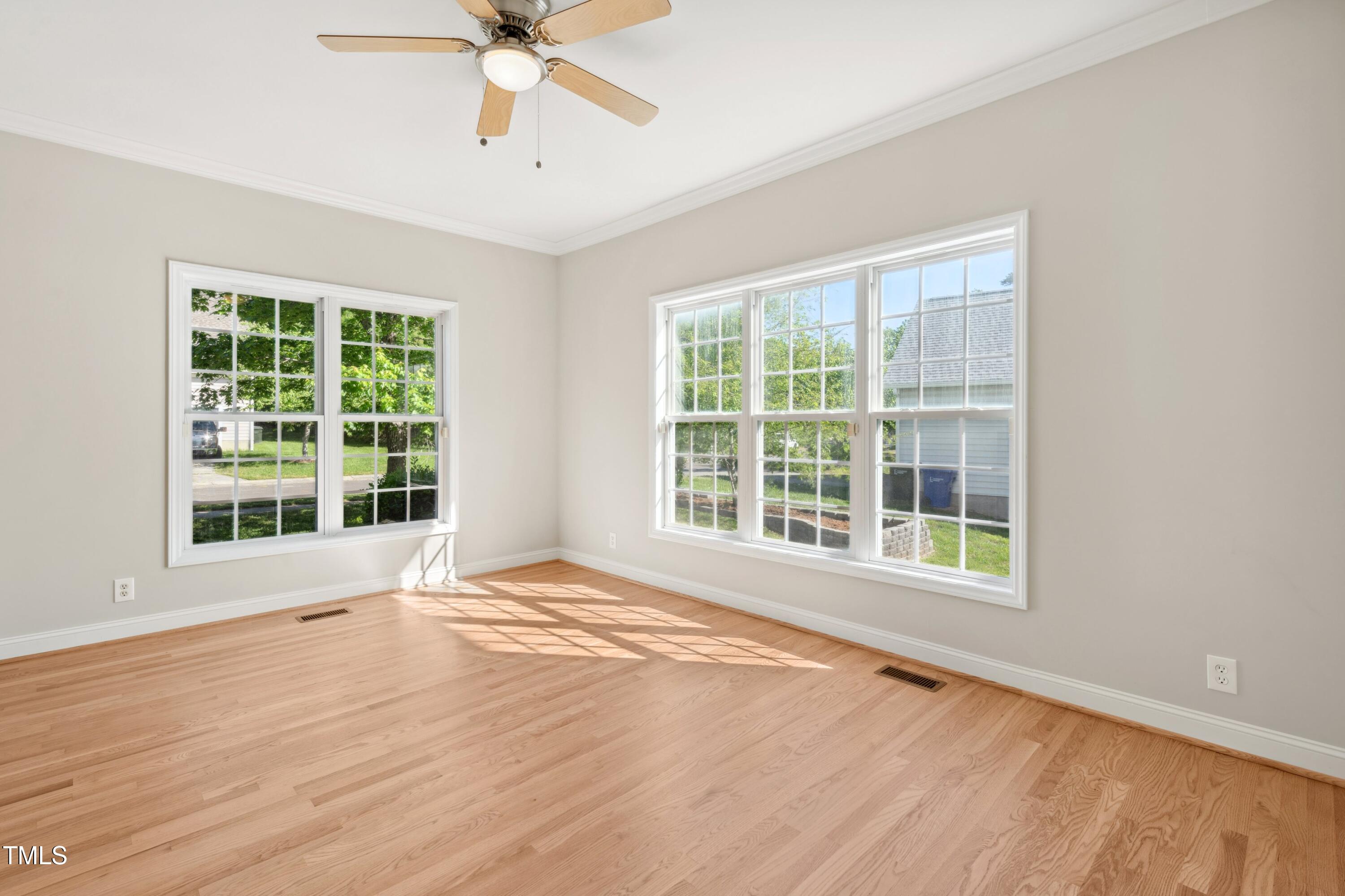 1909 Redding Lane Durham, NC 27712 - Photo 10 of 49 a view of an empty room with a window and wooden floor