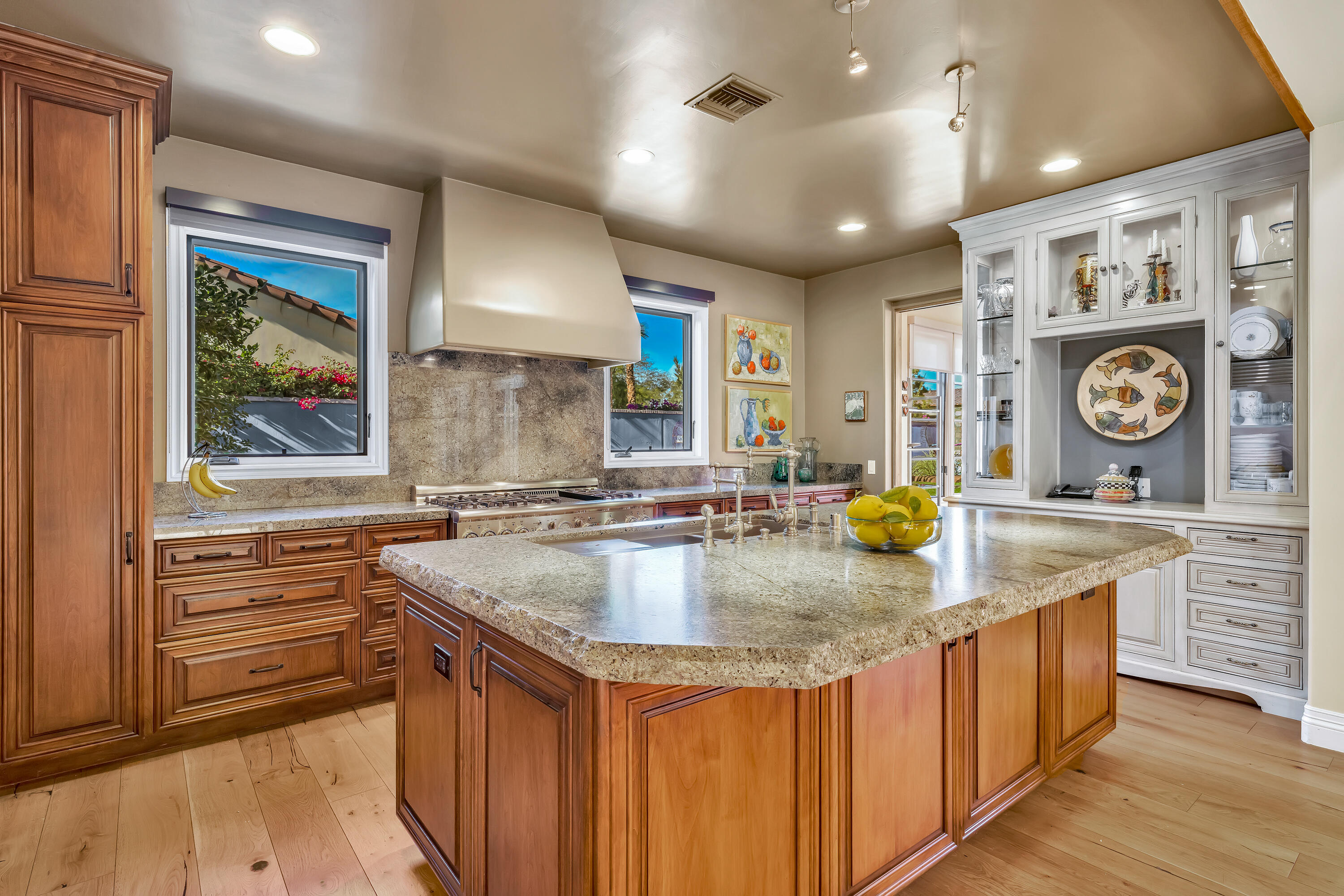 37 Cassis Circle Rancho Mirage, CA 92270 - Photo 16 of 56 a kitchen with kitchen island granite countertop a sink a counter space appliances and a window