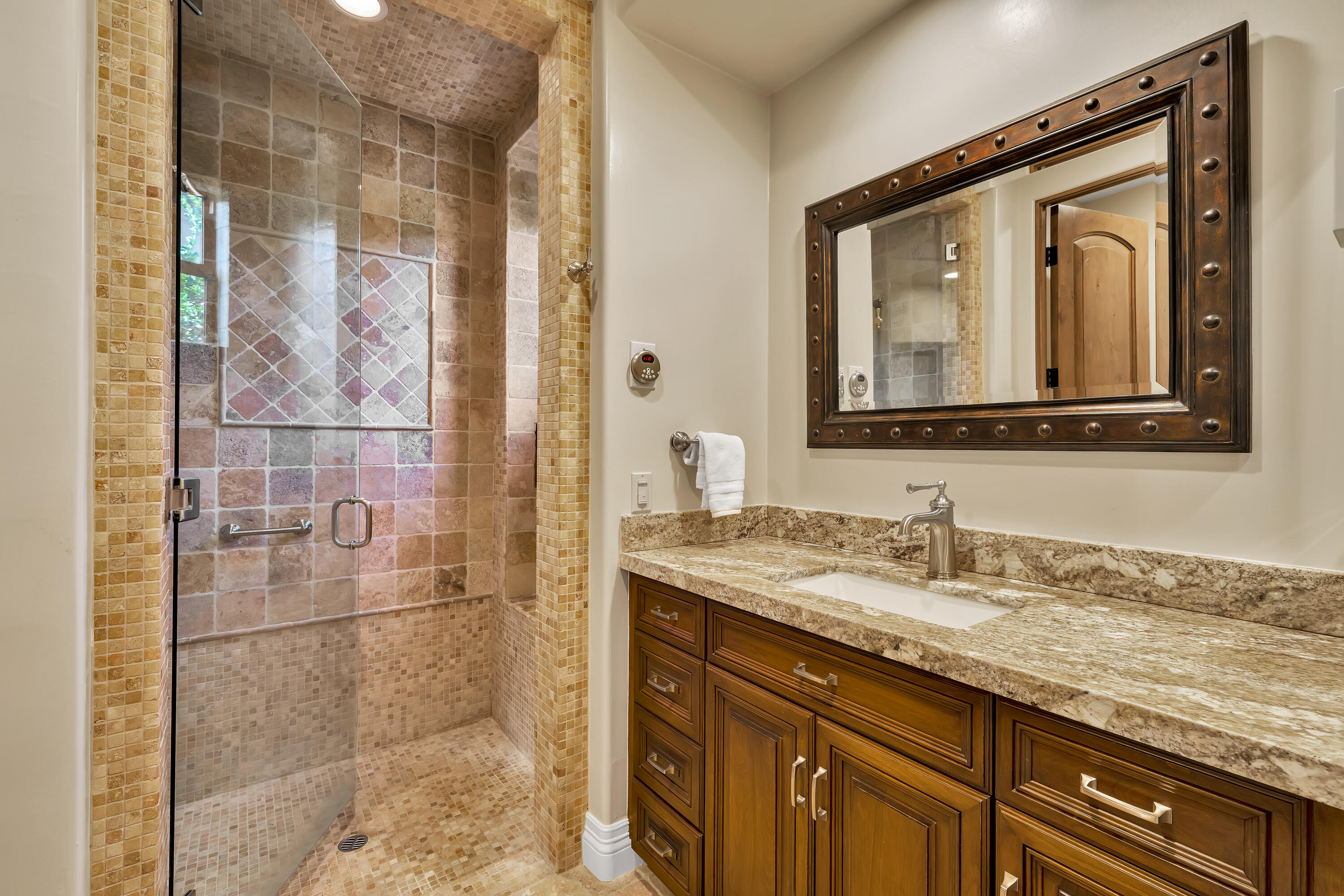 37 Cassis Circle Rancho Mirage, CA 92270 - Photo 31 of 56 a bathroom with a granite countertop sink a mirror and a shower