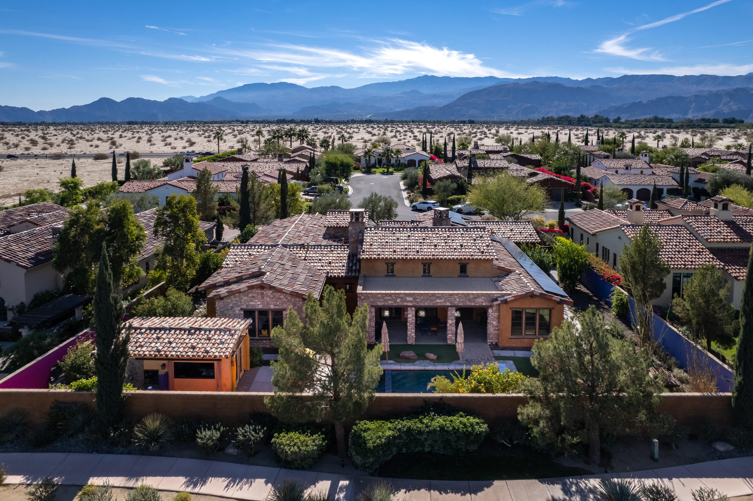 37 Cassis Circle Rancho Mirage, CA 92270 - Photo 56 of 56 a view of a large building with a yard and potted plants