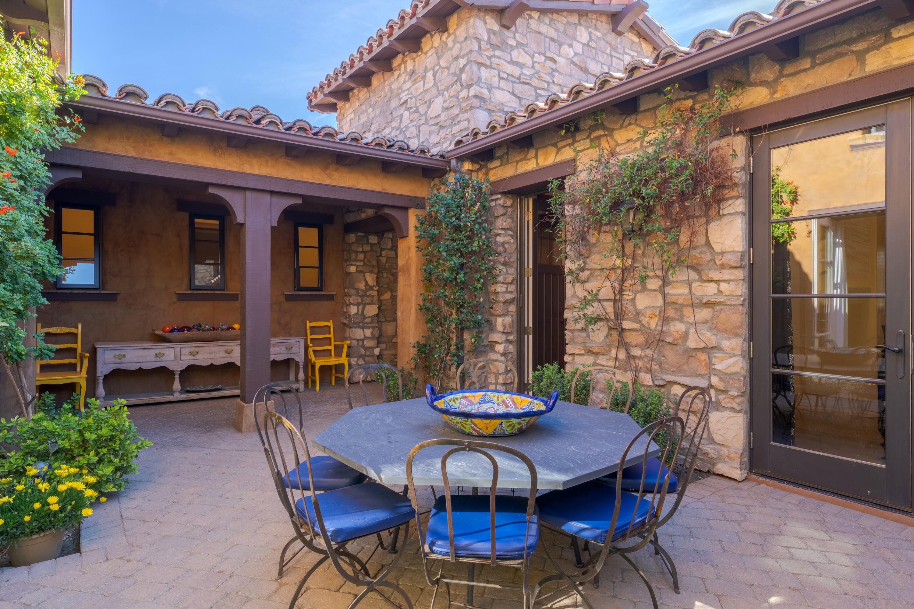 37 Cassis Circle Rancho Mirage, CA 92270 - Photo 8 of 56 a view of a patio with table and chairs and potted plants