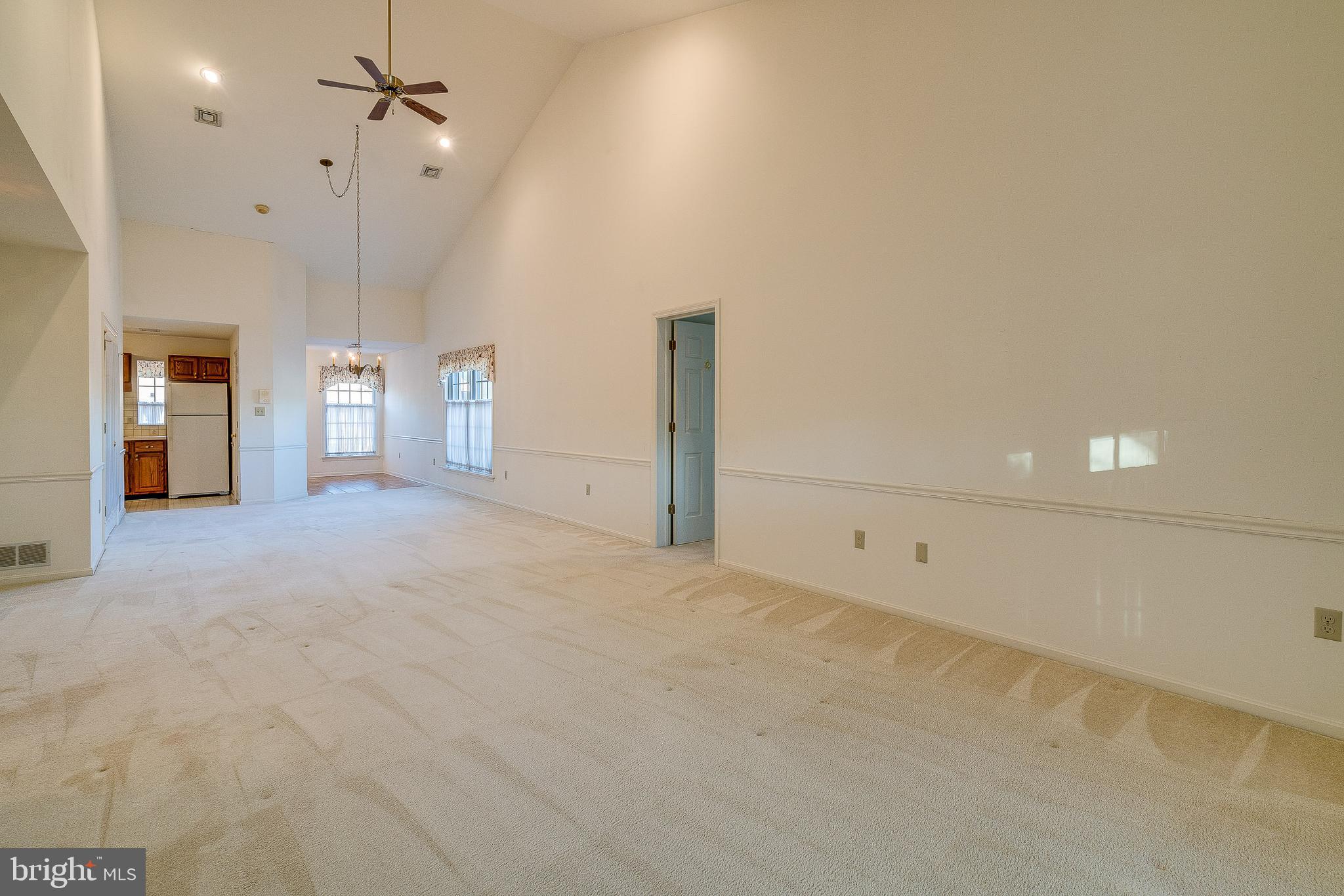 15 Amberly Way Lititz, PA 17543 - Photo 10 of 24 an empty room with chandelier fan and windows