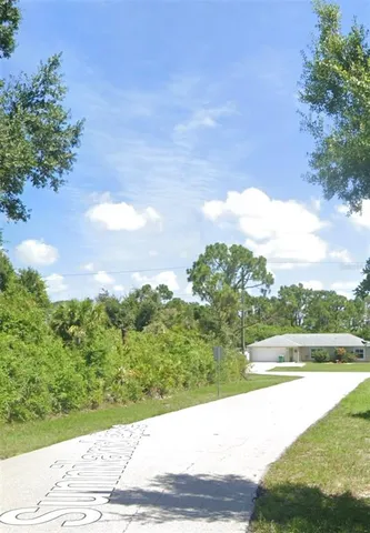 a view of a street with a yard