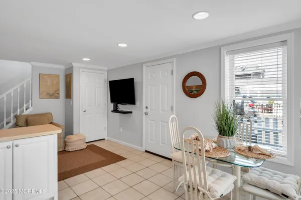 a view of a kitchen with fridge and wooden floor