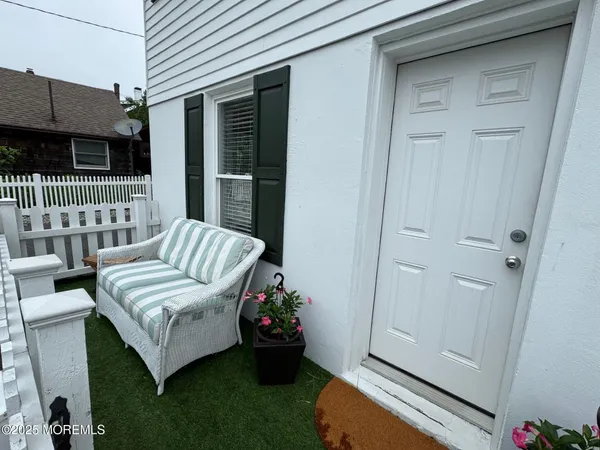 a living room with furniture and flowers