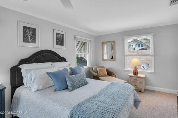 a bedroom with a bed and painting on the wall