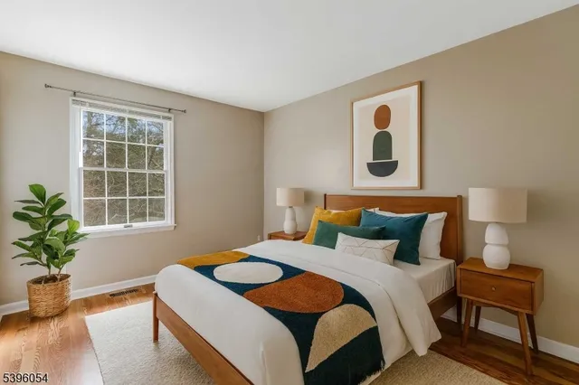 a bedroom with a bed and a potted plant