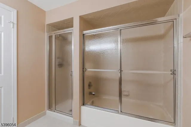 a bathroom with a glass shower door