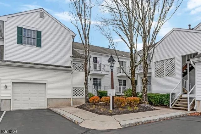 a front view of a house with a yard and potted plants