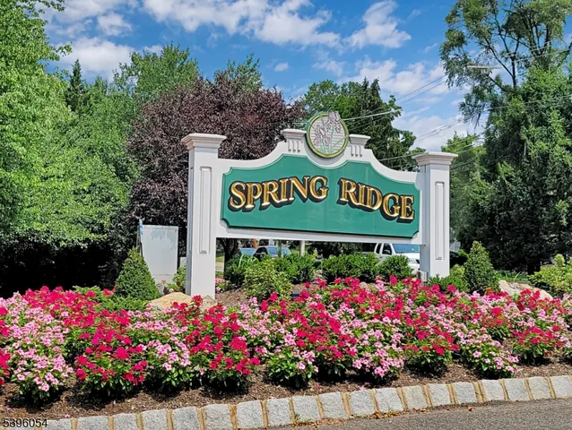 a sign that is in front of flowers