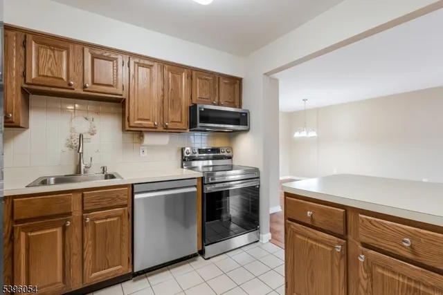 a kitchen with stainless steel appliances granite countertop a stove sink and cabinets