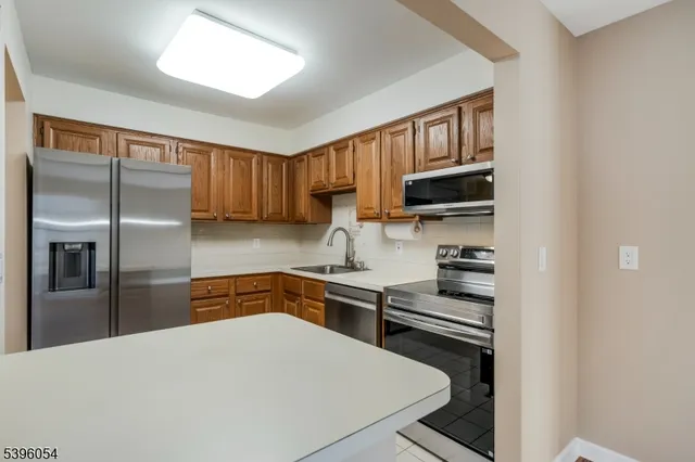a kitchen with a refrigerator stove and sink