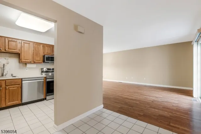 a view of a kitchen with microwave and cabinets