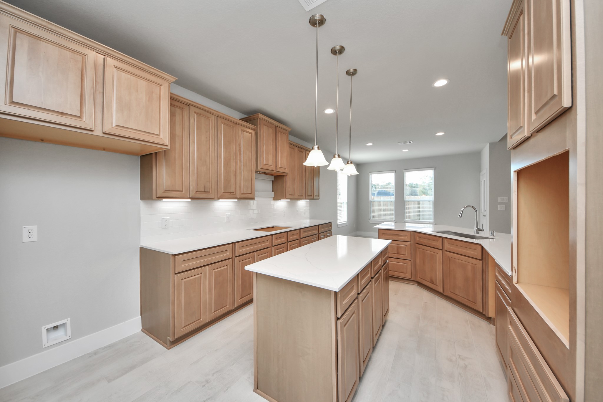 3109 North Spring Drive Spring, TX 77373 - Photo 15 of 50 The extended counter area adds both practicality and style, making meal preparation a breeze. Every detail is thoughtfully designed to enhance the kitchen's functionality and aesthetic appeal.