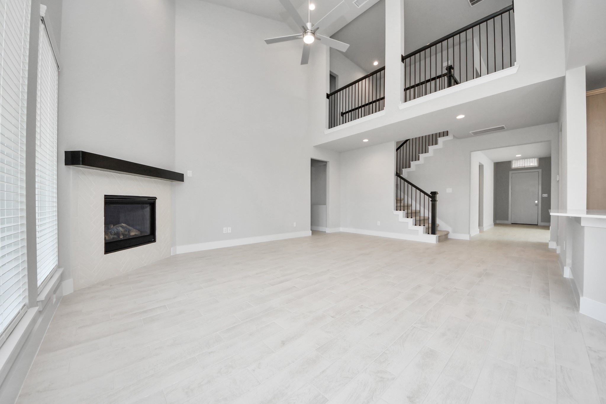 3109 North Spring Drive Spring, TX 77373 - Photo 21 of 50 Welcome family and guests to your charming living room! With its high ceilings, recessed lighting, ceiling fan, custom paint, beautiful flooring, and large windows that let in abundant natural light, this room is perfect for gatherings.