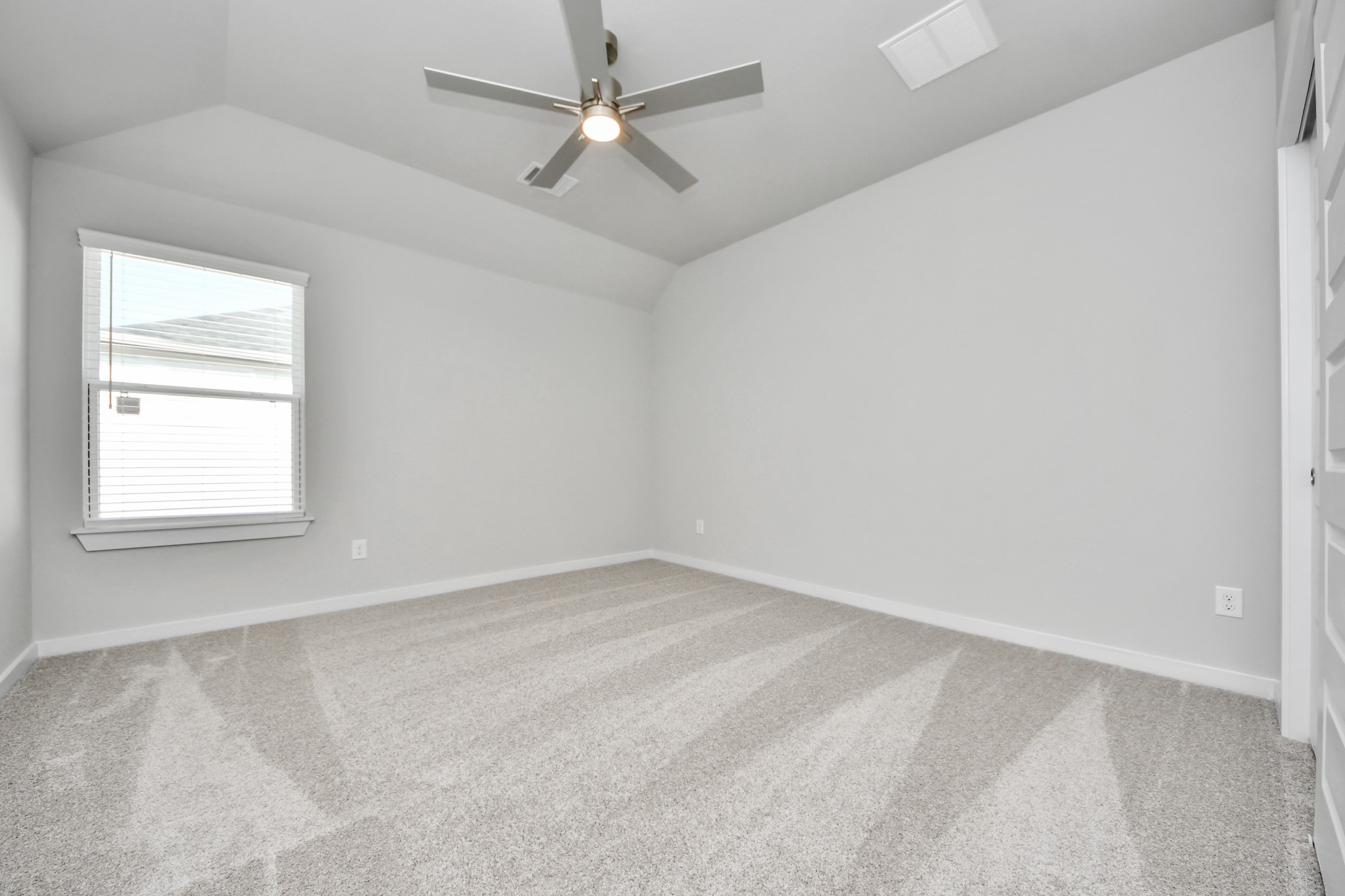3109 North Spring Drive Spring, TX 77373 - Photo 41 of 50 Secondary bedroom features plush carpeting, large windows that let in plenty of natural light, bright paint, and spacious closets.