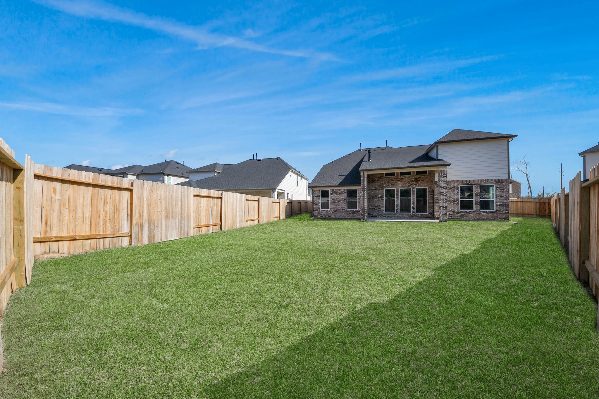 3109 North Spring Drive Spring, TX 77373 - Photo 45 of 50 Explore the expansive backyard with its inviting covered patio—a perfect blend of space for the kids to play and adults to unwind. Ideal for creating your outdoor oasis, this backyard accommodates patio furniture, a BBQ pit, and endless possibilities for leisure and entertainment.