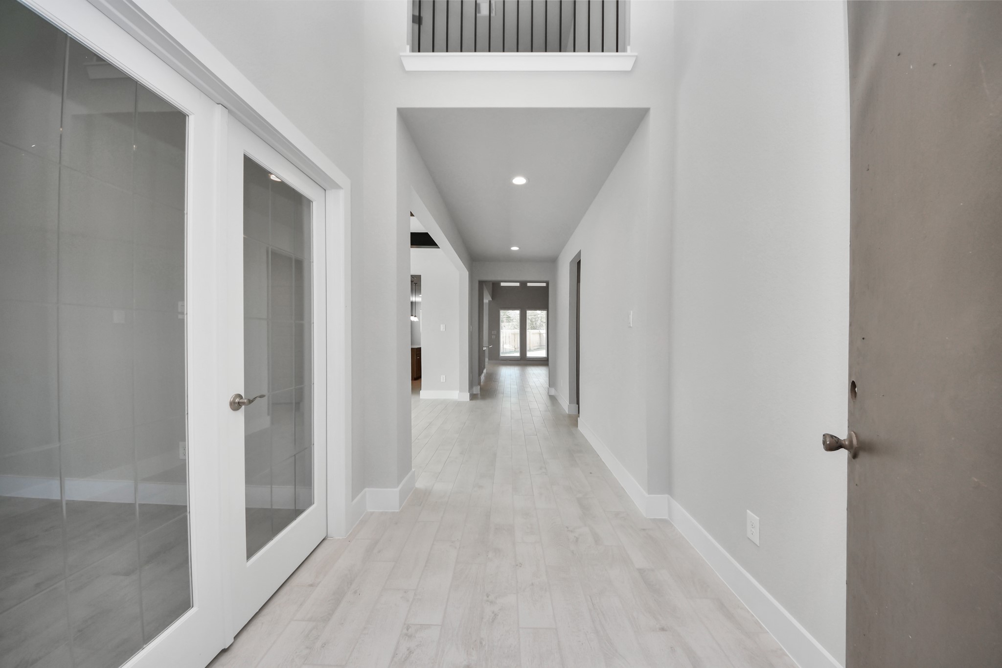 3109 North Spring Drive Spring, TX 77373 - Photo 6 of 50 As you step into the threshold of this luxurious home, you'll soon be welcomed by an elegant glass door (to be installed). Inside, soaring ceilings amplify the spaciousness, while the refined wood-look tile flooring and oversized baseboards exude sophistication and charm.