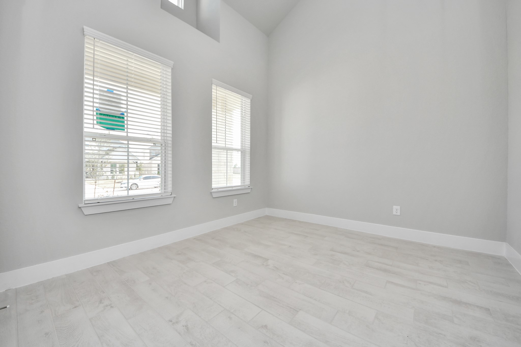3109 North Spring Drive Spring, TX 77373 - Photo 8 of 50 Step into the inviting home office, where elegant tile flooring adds a touch of freshness and comfort to the workspace. Natural light pours through the window, creating an inspiring environment for productivity and focus.