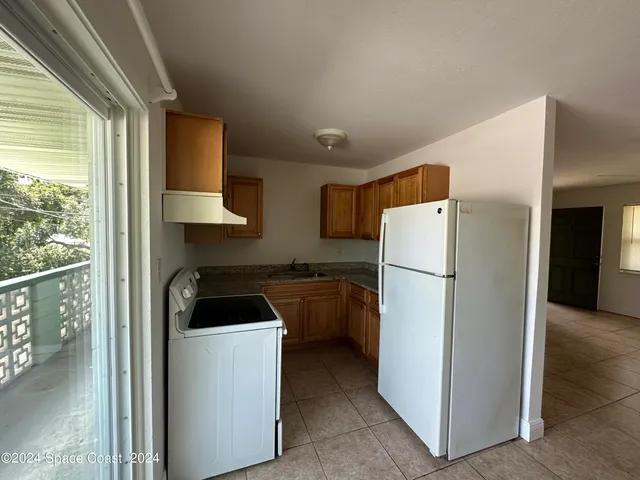 a kitchen with a refrigerator and a sink