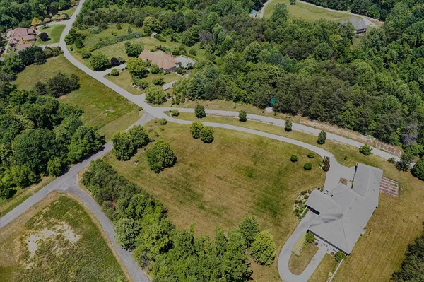 an aerial view of a house with a yard
