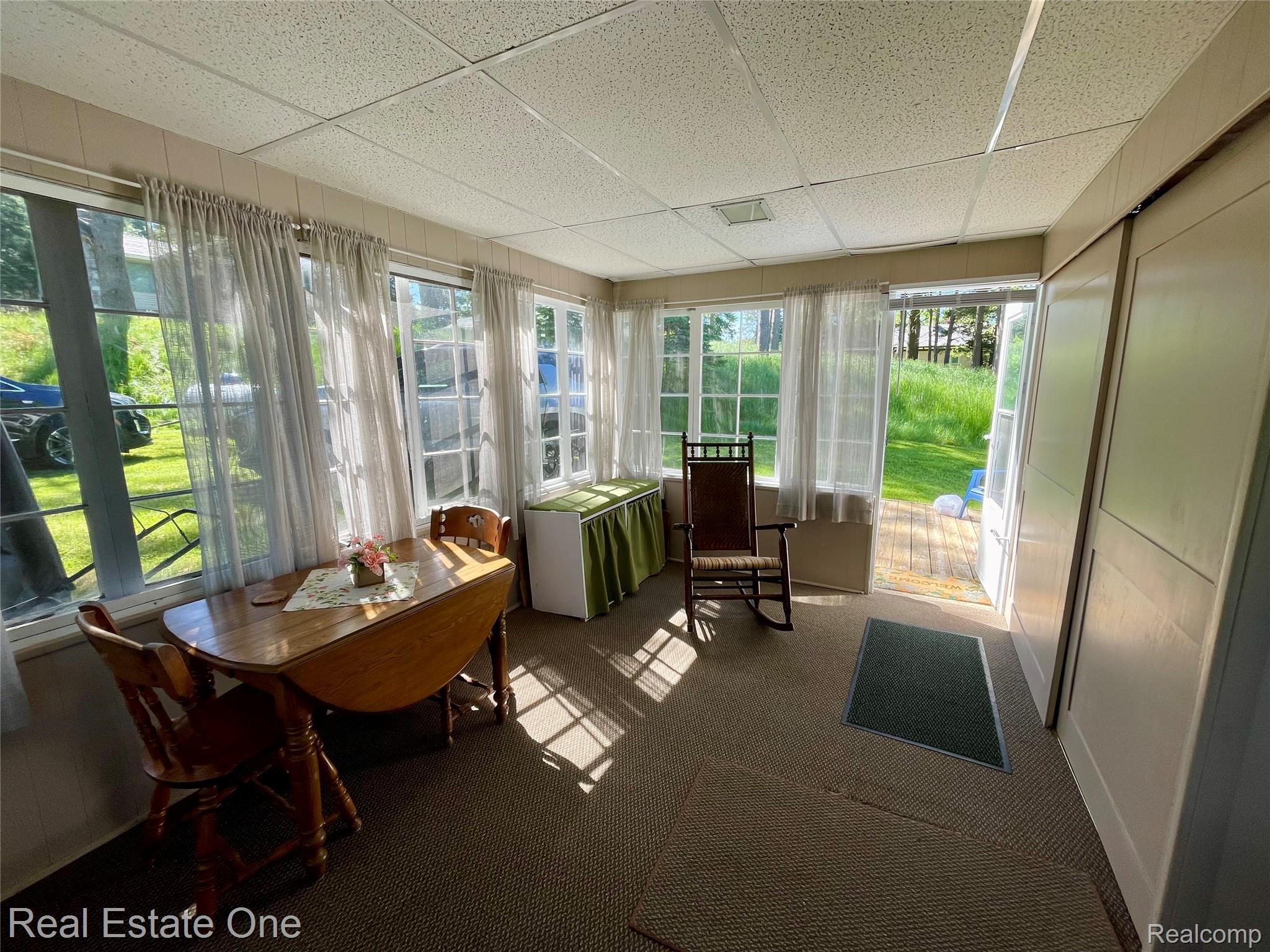 4160 Hawk Road Lincoln, MI 48742 - Photo 21 of 48 Sunroom featuring multiple window units, wall-to-wall carpeting, and a drop ceiling