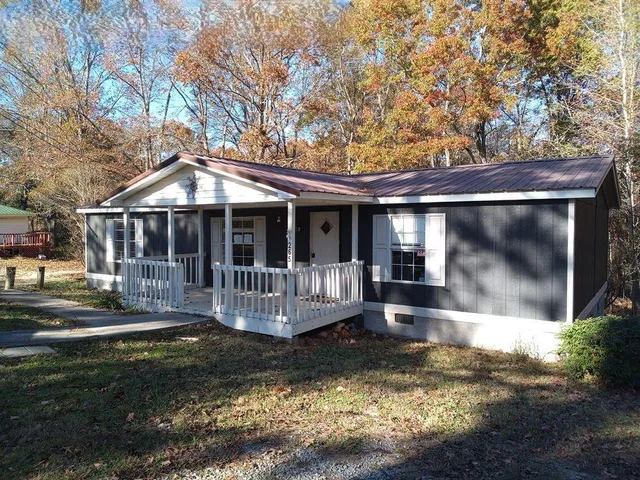 a view of house with a yard
