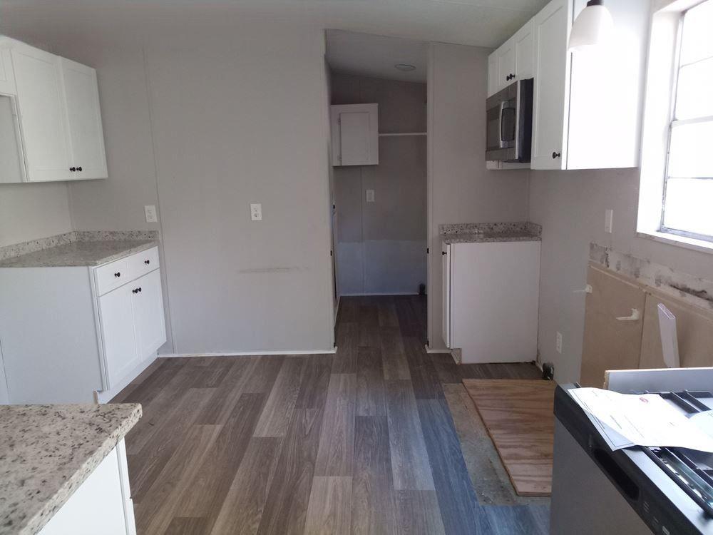 265 Perry Lane Buchanan, GA 30113 - Photo 12 of 20 a room with wooden floor and cabinets