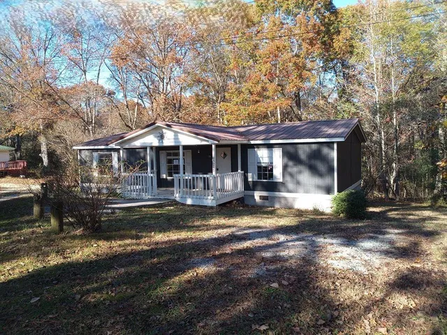 a front view of a house with a yard balcony