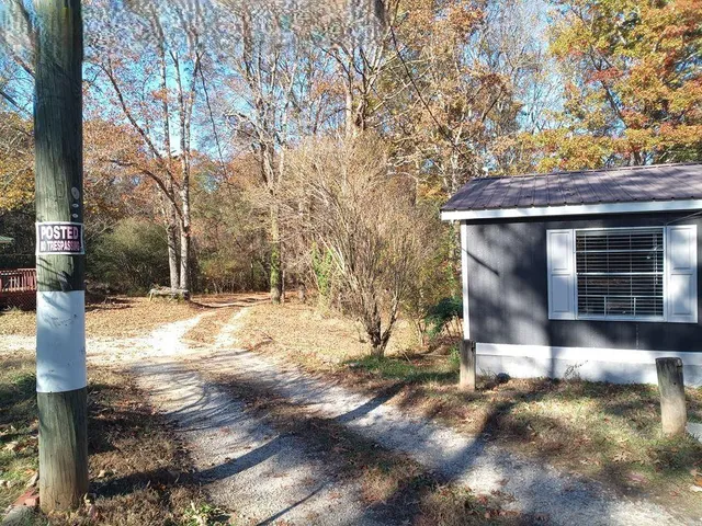 a front view of a house with a yard covered with snow