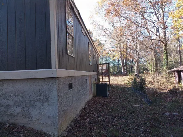 a view of backyard with large trees