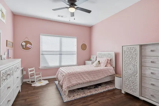 a living room with furniture kitchen view and a wooden floor