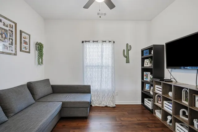 a kitchen with stainless steel appliances granite countertop a stove a kitchen island a dining table and chairs with wooden floor