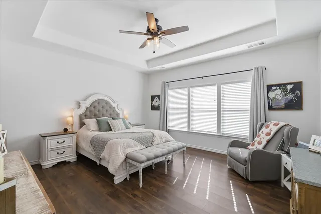 a bedroom with bed couch and window