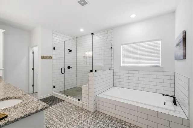a bathroom with a bathtub and a shower