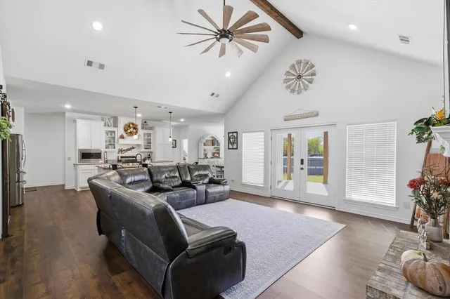 a view of a workspace with furniture and wooden floor