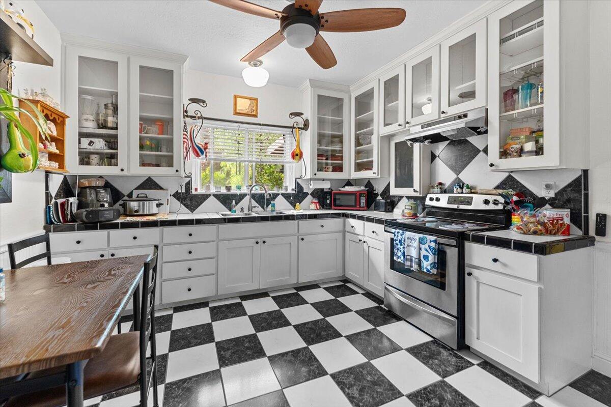 931 Rio Street Red Bluff, CA 96080 - Photo 15 of 54 a kitchen with stainless steel appliances a stove a sink and a cabinets