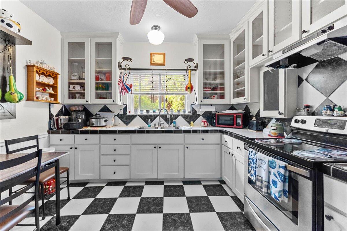 931 Rio Street Red Bluff, CA 96080 - Photo 16 of 54 a kitchen with stainless steel appliances a sink and a stove