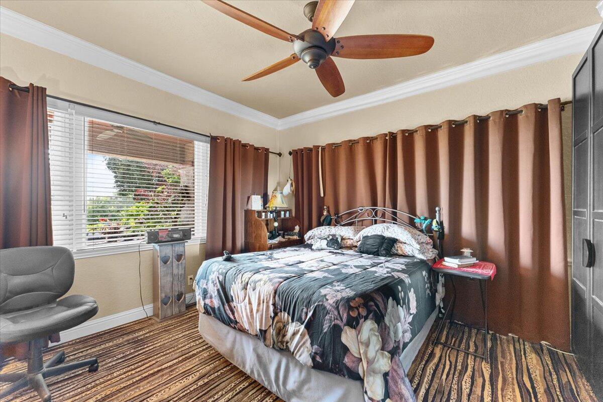 931 Rio Street Red Bluff, CA 96080 - Photo 18 of 54 a bedroom with a bed and a chandelier