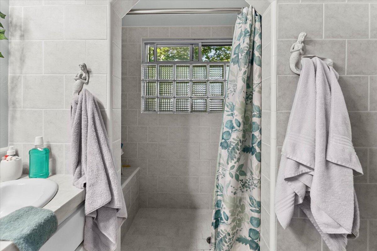 931 Rio Street Red Bluff, CA 96080 - Photo 21 of 54 a bathroom with a shower curtain and a large window