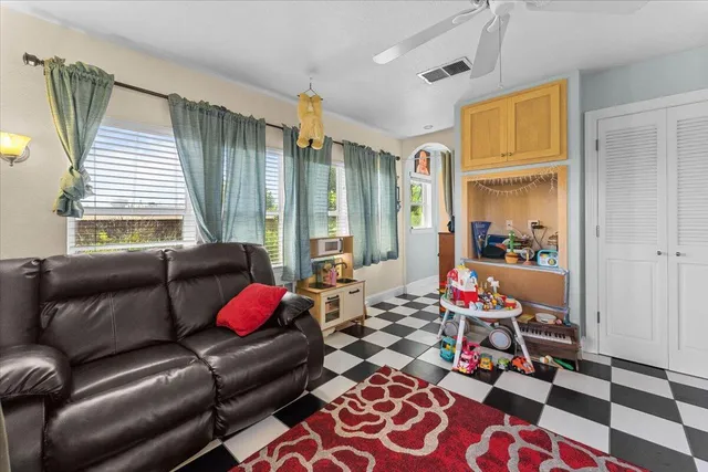 a bedroom with a bed and a large window