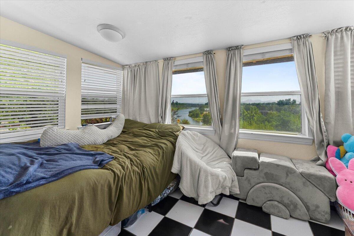 931 Rio Street Red Bluff, CA 96080 - Photo 31 of 54 a bedroom with a bed and a large window