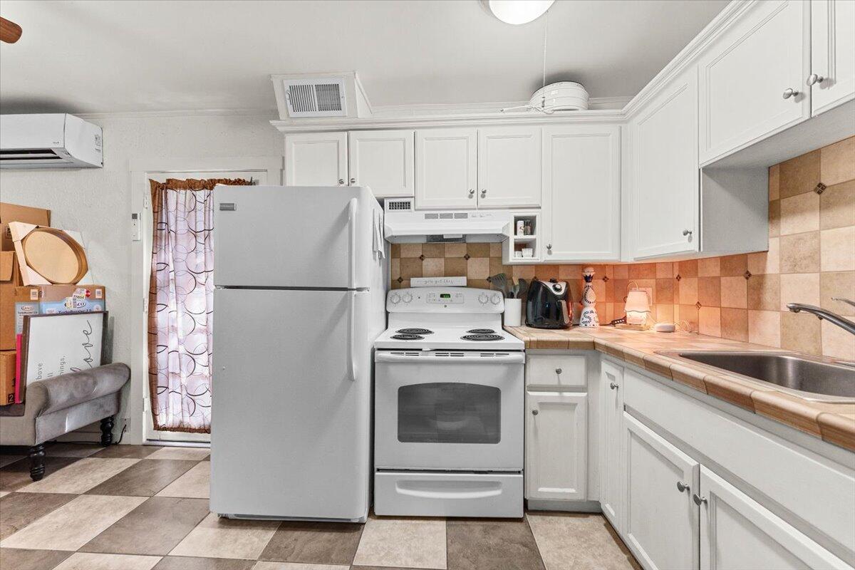931 Rio Street Red Bluff, CA 96080 - Photo 36 of 54 a kitchen with a refrigerator sink and cabinets