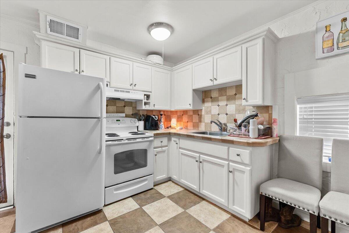 931 Rio Street Red Bluff, CA 96080 - Photo 37 of 54 a kitchen with stainless steel appliances a refrigerator sink and cabinets
