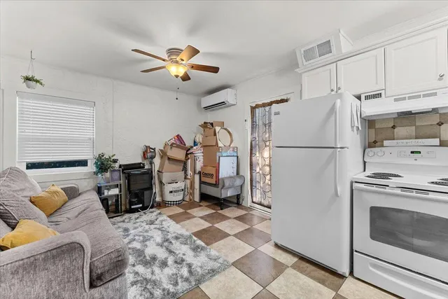 a backyard of a house with plants and large trees